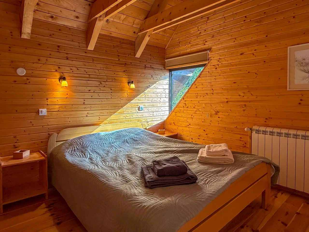The second bedroom with a double bed and a sloping window