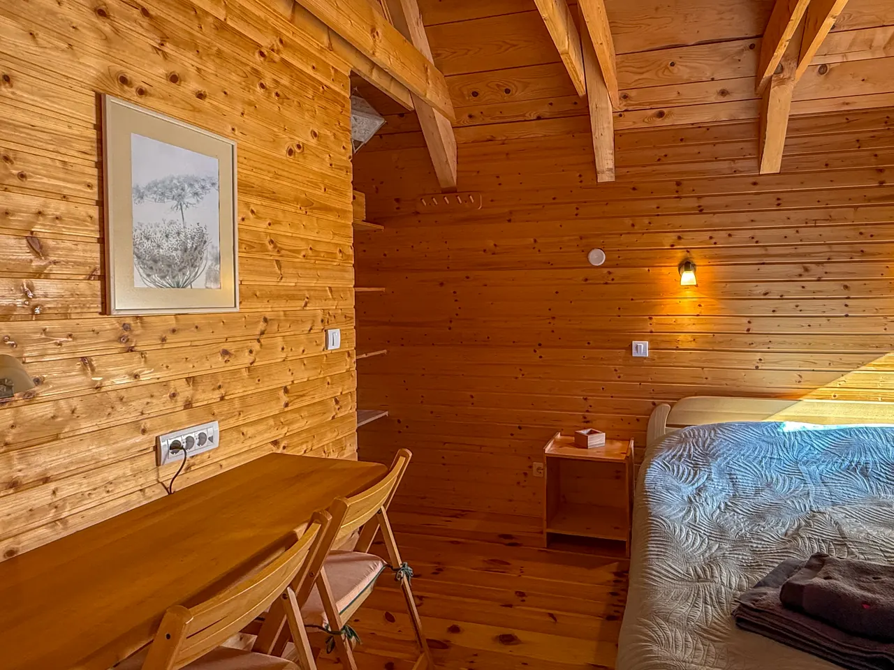 A small desk and a double bed in the second bedroom