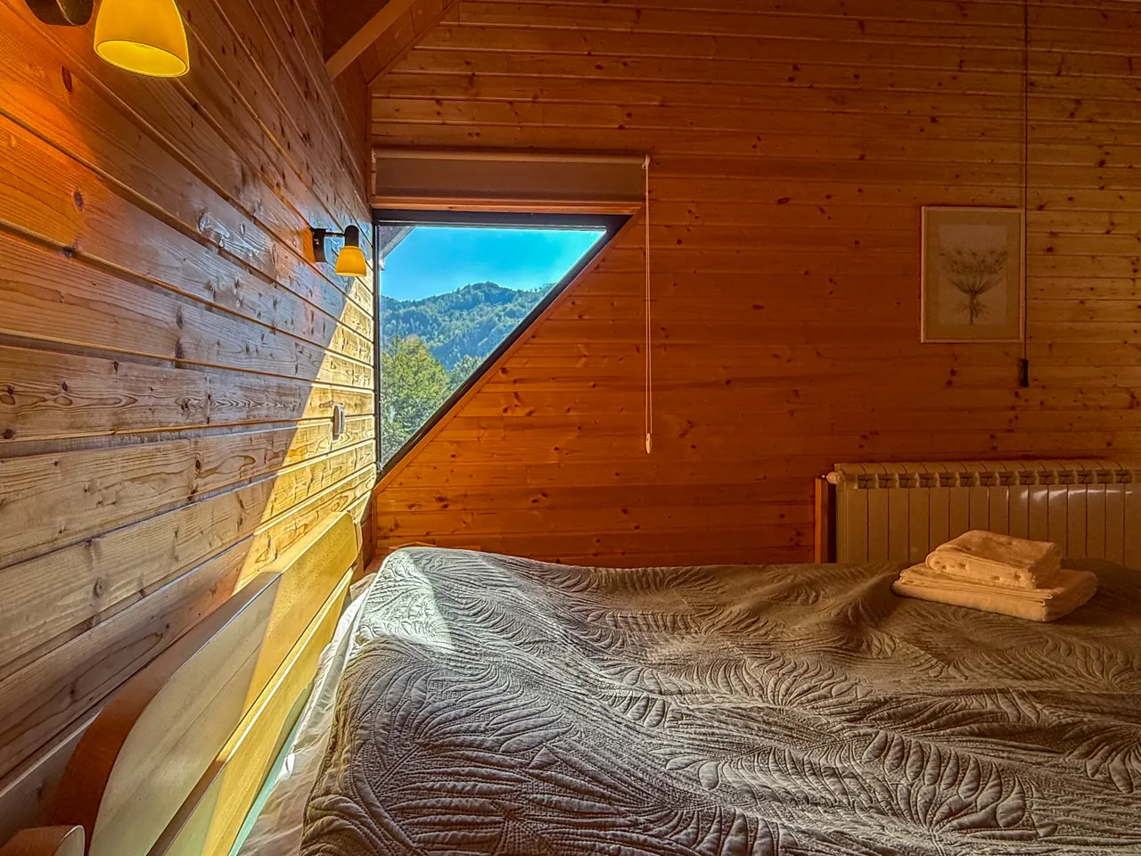 A triangular window with a view of the mountains