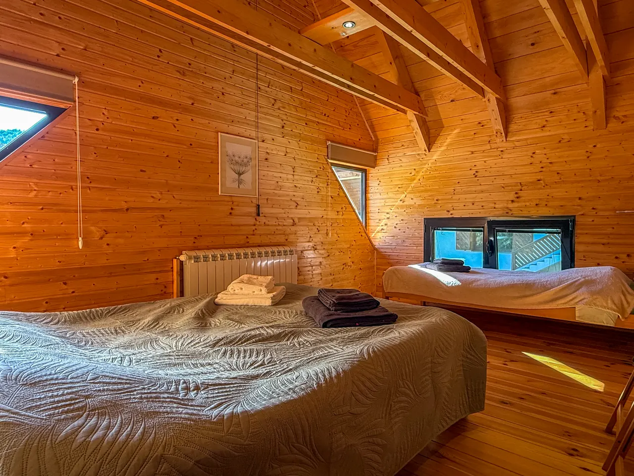 The second bedroom under the exposed roof beams