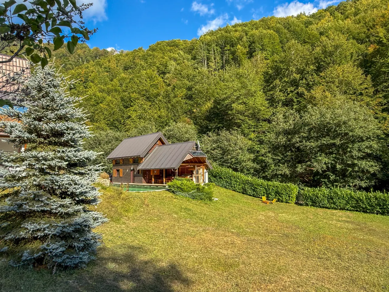 The cabin seen from the meadow above